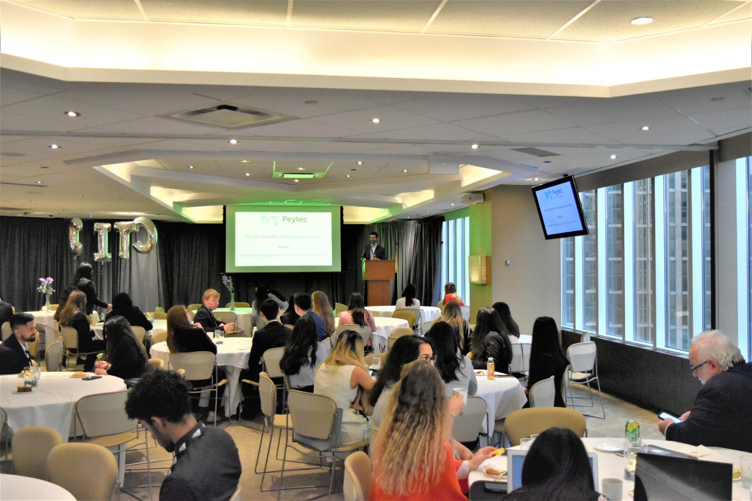 Peyman Moeini presenting to an audience at an event